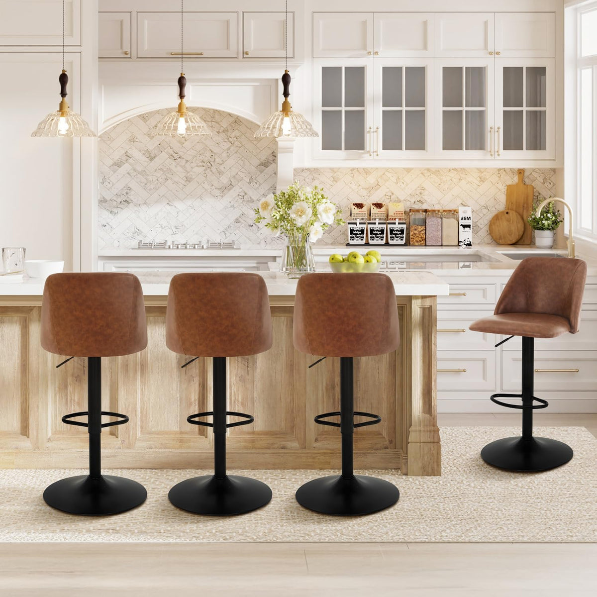 Three brown bar stools shown from the back at the island and a fourth brown stool turned toward the camera