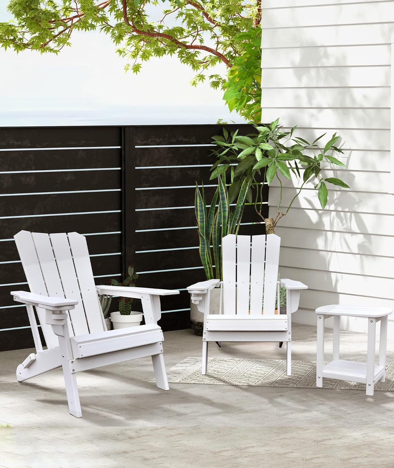 White Adirondack chairs with matching white side table on a patio setting
