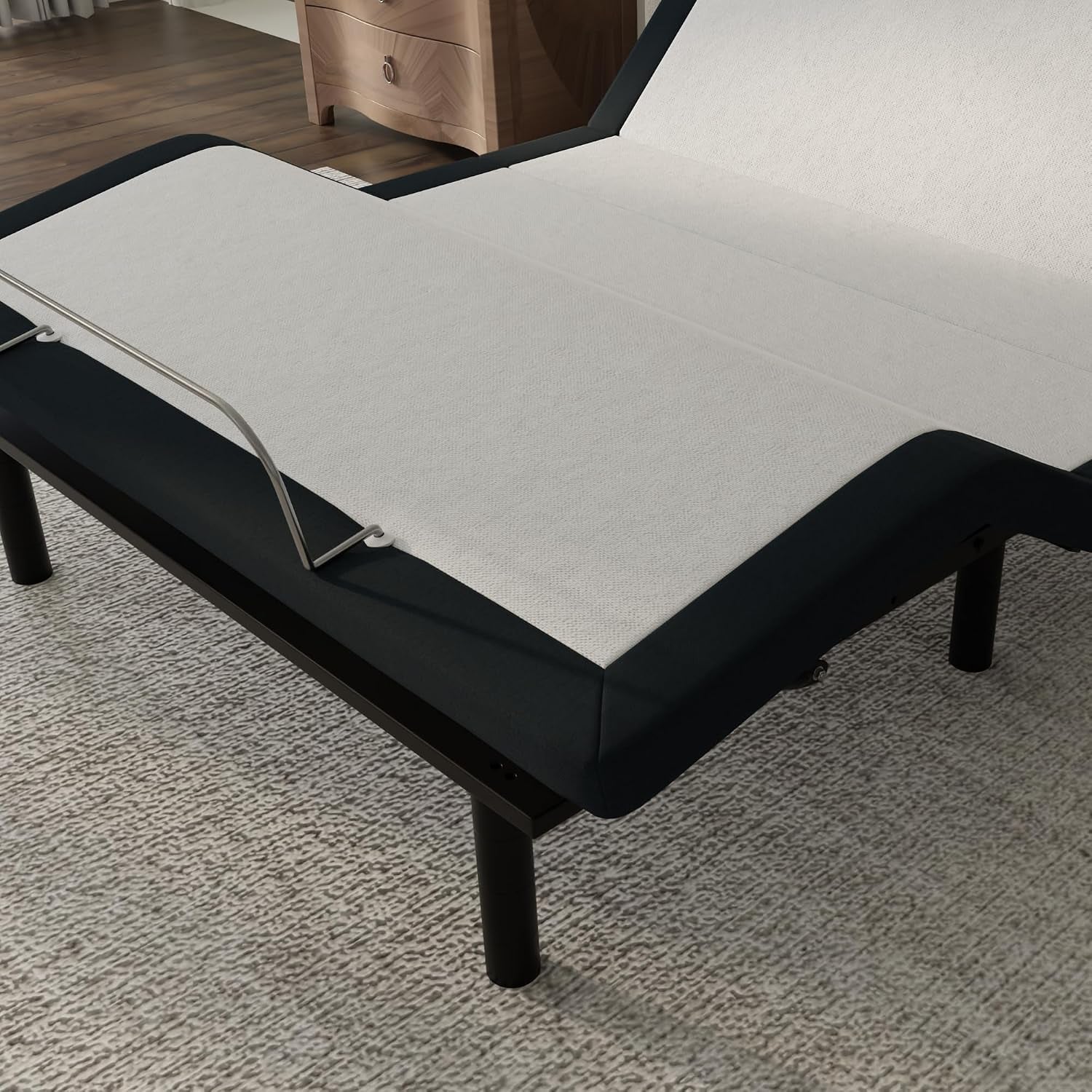 Close-up of adjustable base foot section showing white fabric deck, metal mattress retainer and black screw-in leg