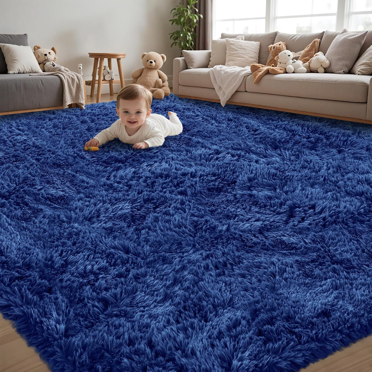 Main room shot of a deep blue fluffy shag rug with a baby crawling and neutral sofas and toys behind.