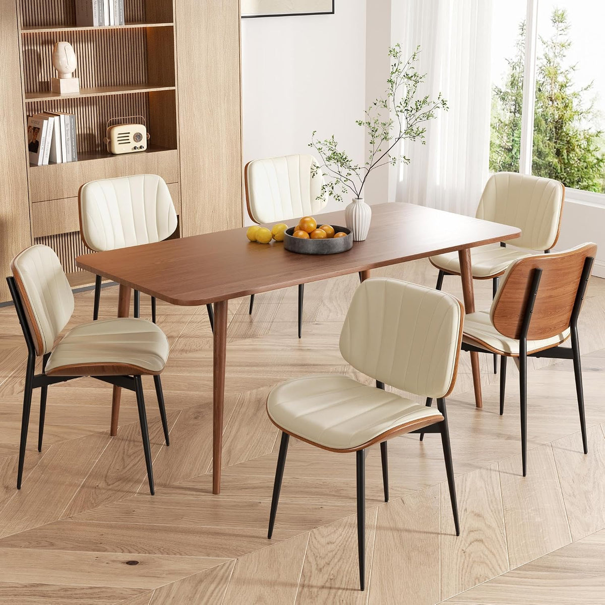 Wooden dining table set with six cream-colored faux leather chairs and decorative bowl on the table