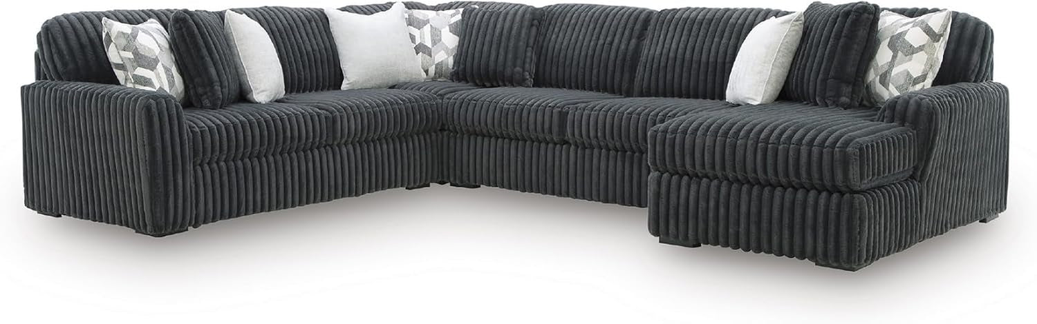 Angled left view of a large dark corduroy sectional with ribbed texture and assorted throw pillows.