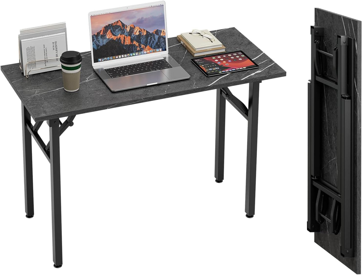 Desk seen from above with laptop, tablet, cup and book stack, showing folding legs and an upright folded tabletop at right