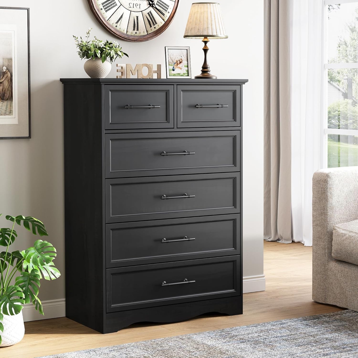 Black 6-drawer chest styled in a living room setting with lamp and decor on top