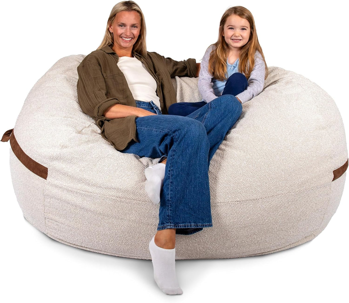 Low front view showing textured beige cover and a woman and child seated with crossed legs over the edge.