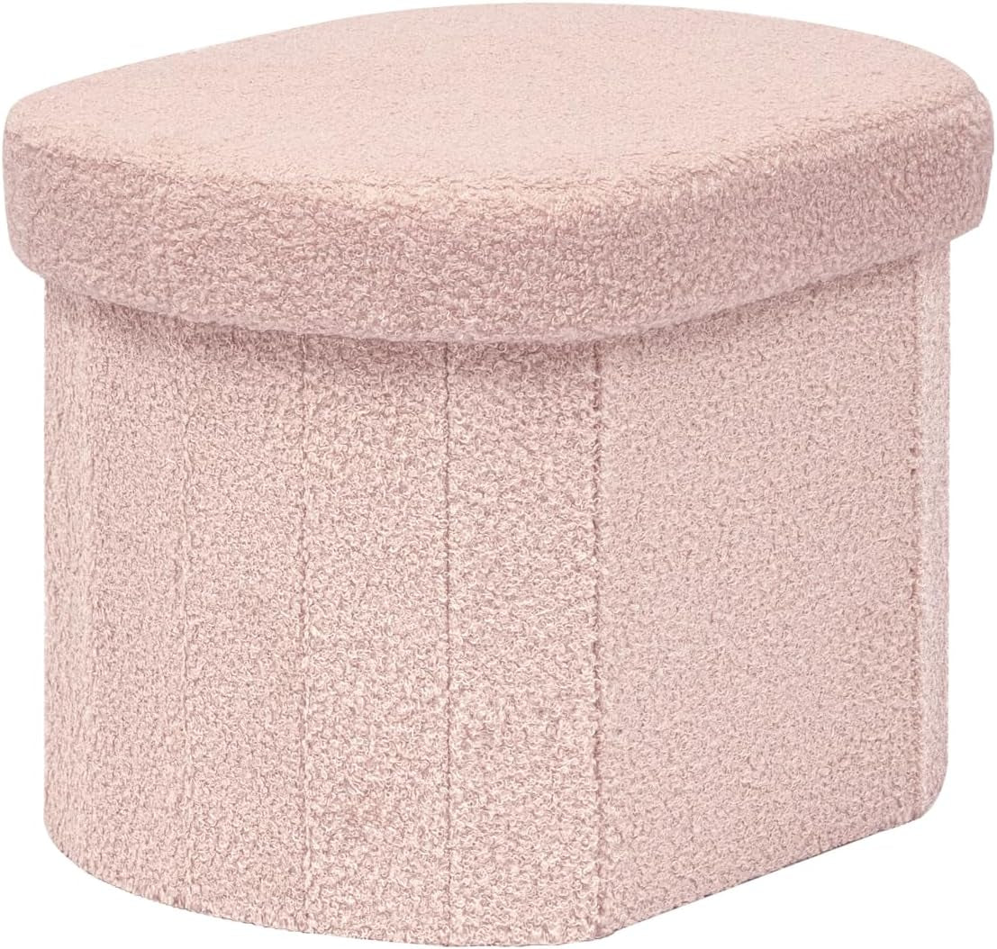 Small rounded rectangular ottoman in light pink sherpa fabric, shown on white background.