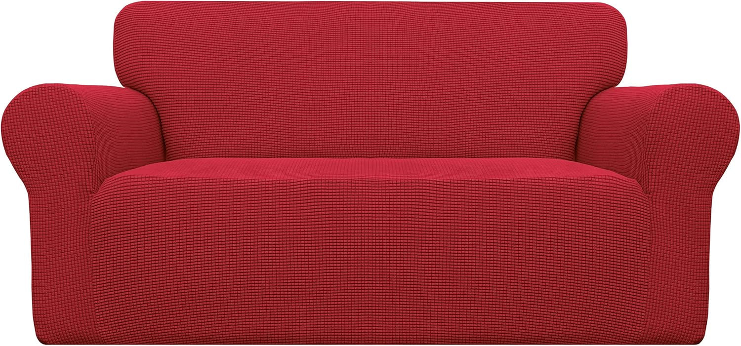 Front-facing two-seat loveseat draped in a bright red textured stretch slipcover against white background.