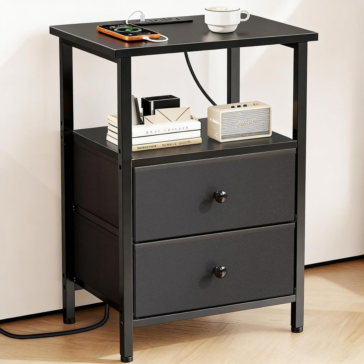 Tight view of the lower two fabric drawers, round drawer knobs, metal legs and adjustable feet on the nightstand.