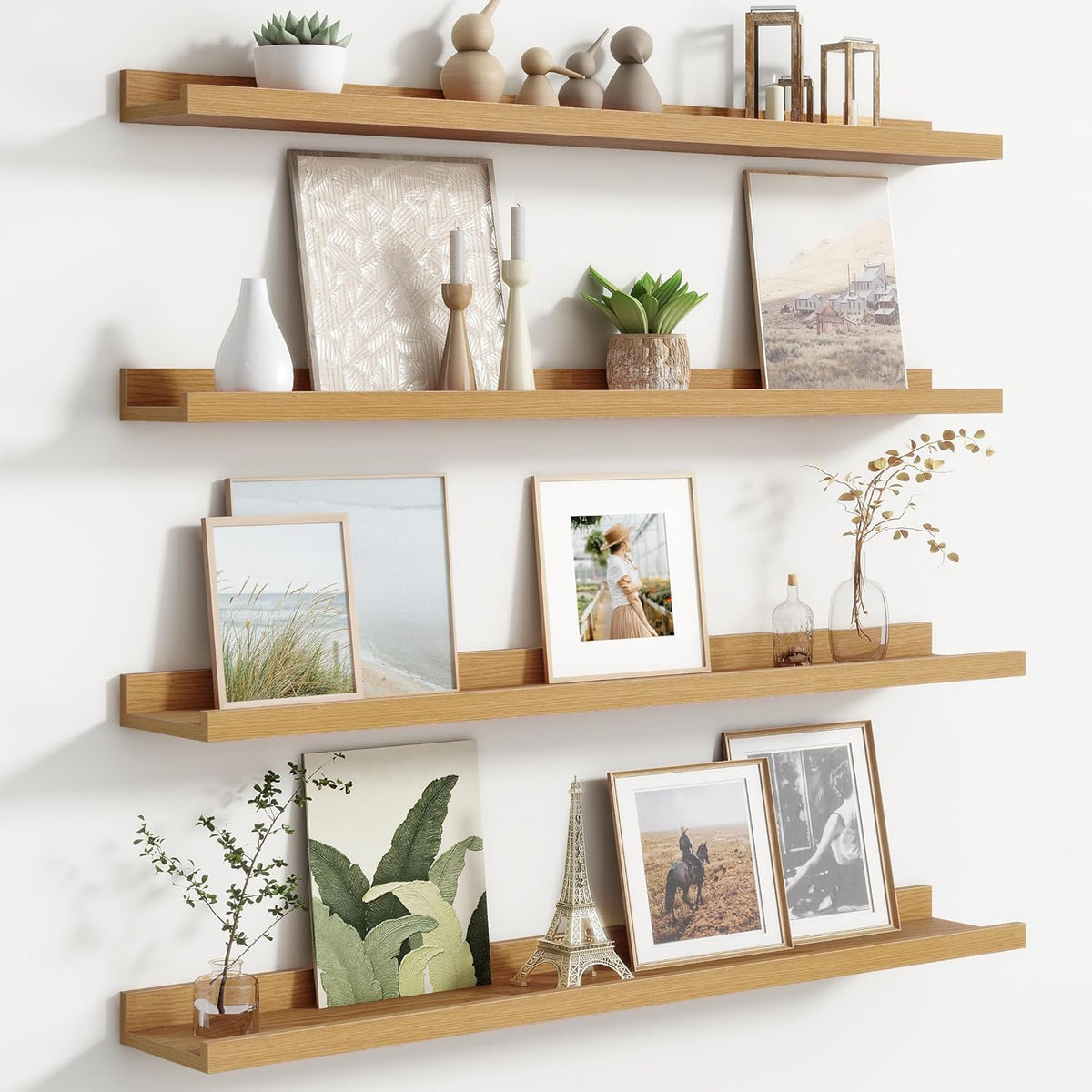 Three horizontal light‑wood floating ledges styled with framed art, plants and small decor.