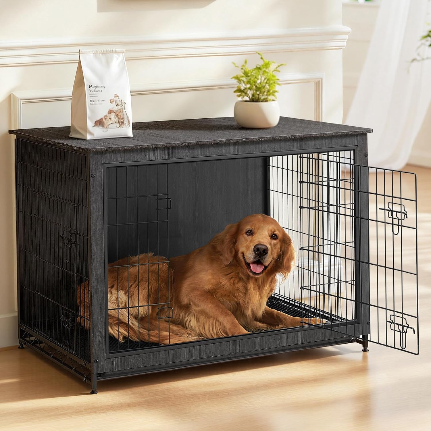 Black wood dog crate in a room with open door and a golden retriever lying inside, plant and bag on top.