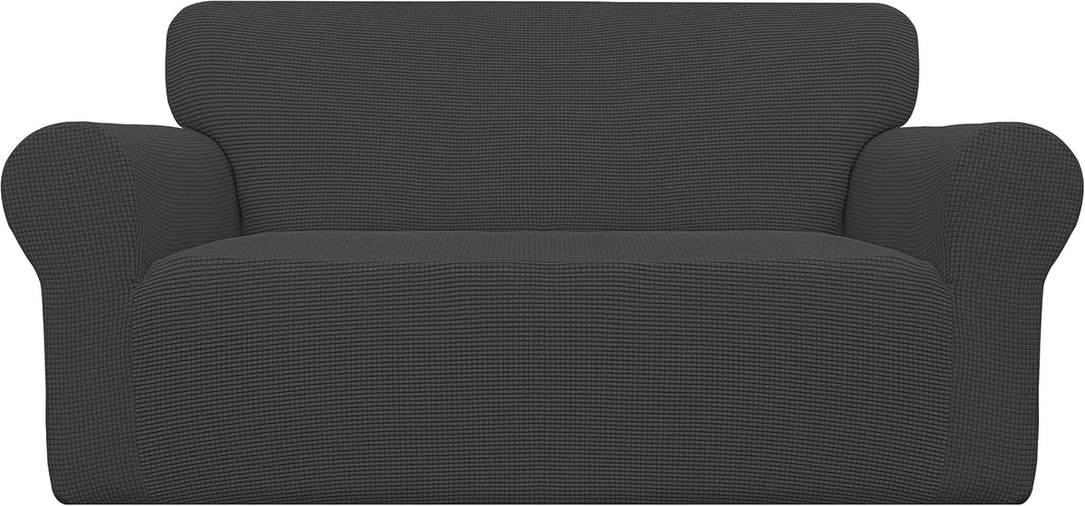 Front studio shot of a dark charcoal loveseat cover showing tucked lower edge and subtle ribbed texture.