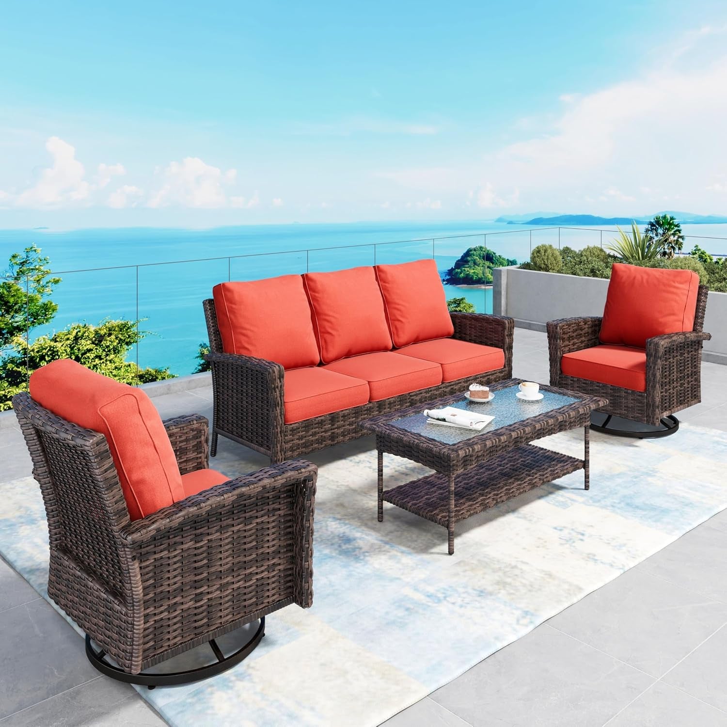 Outdoor patio set with three-seat wicker sofa, two swivel chairs and coffee table with red cushions