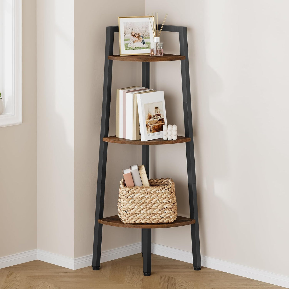 Close crop of the shelf mid-section showing a framed photo and reed diffuser on the top tier, books on the middle shelf and