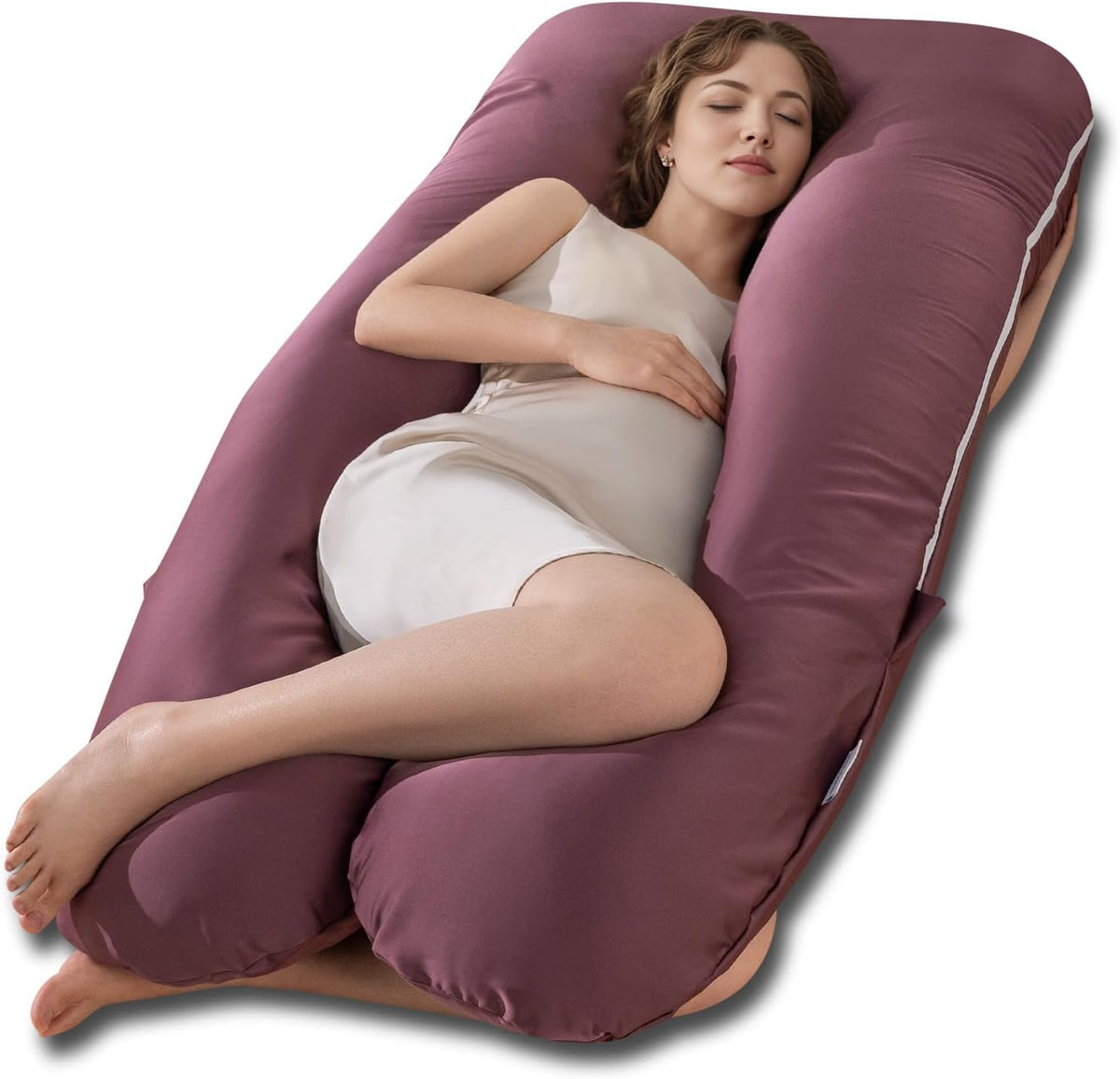 Pregnant woman sleeping supported by a deep mauve U-shaped maternity body pillow.