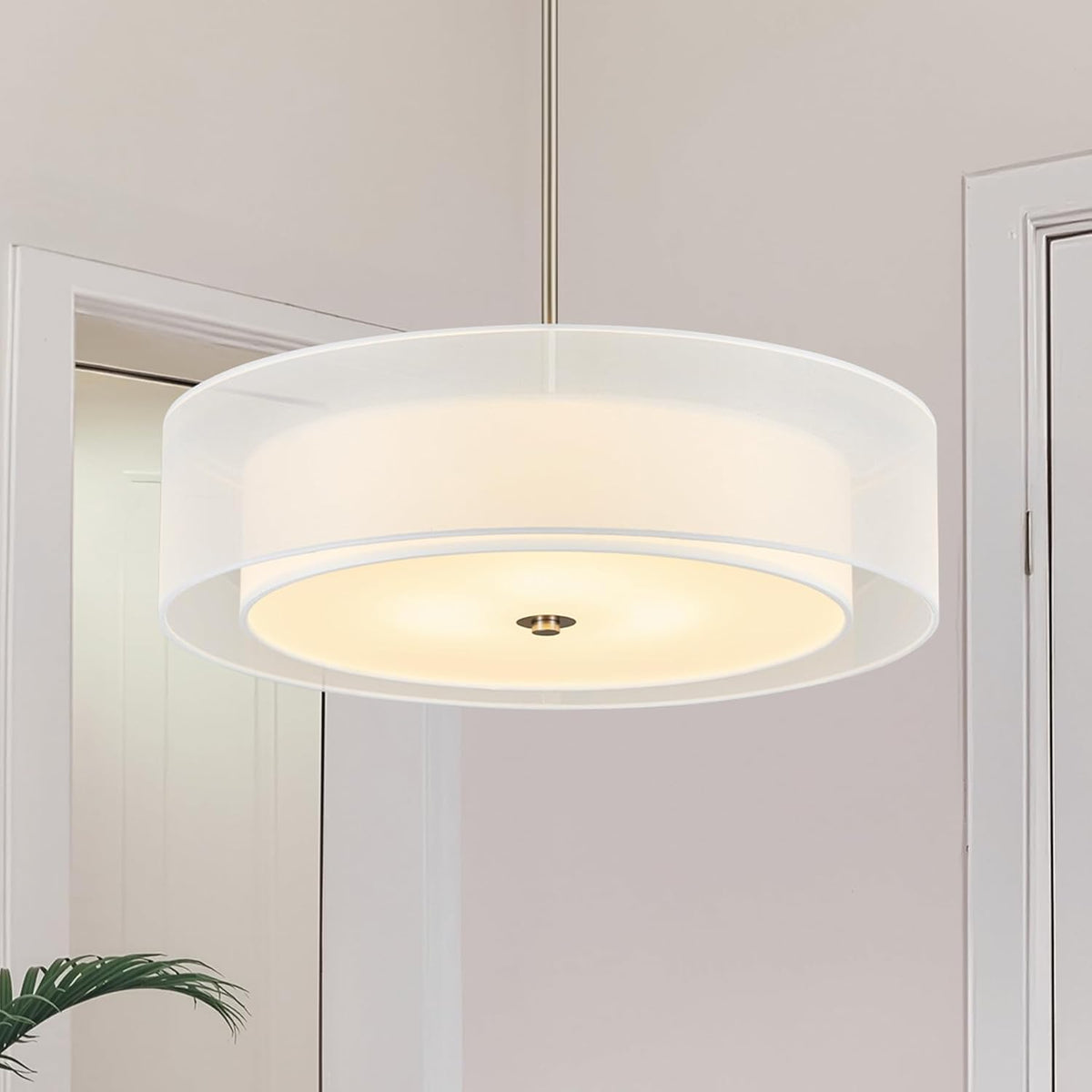 Tight view of a two-tier drum chandelier with a translucent outer drum and silvery suspension rod.