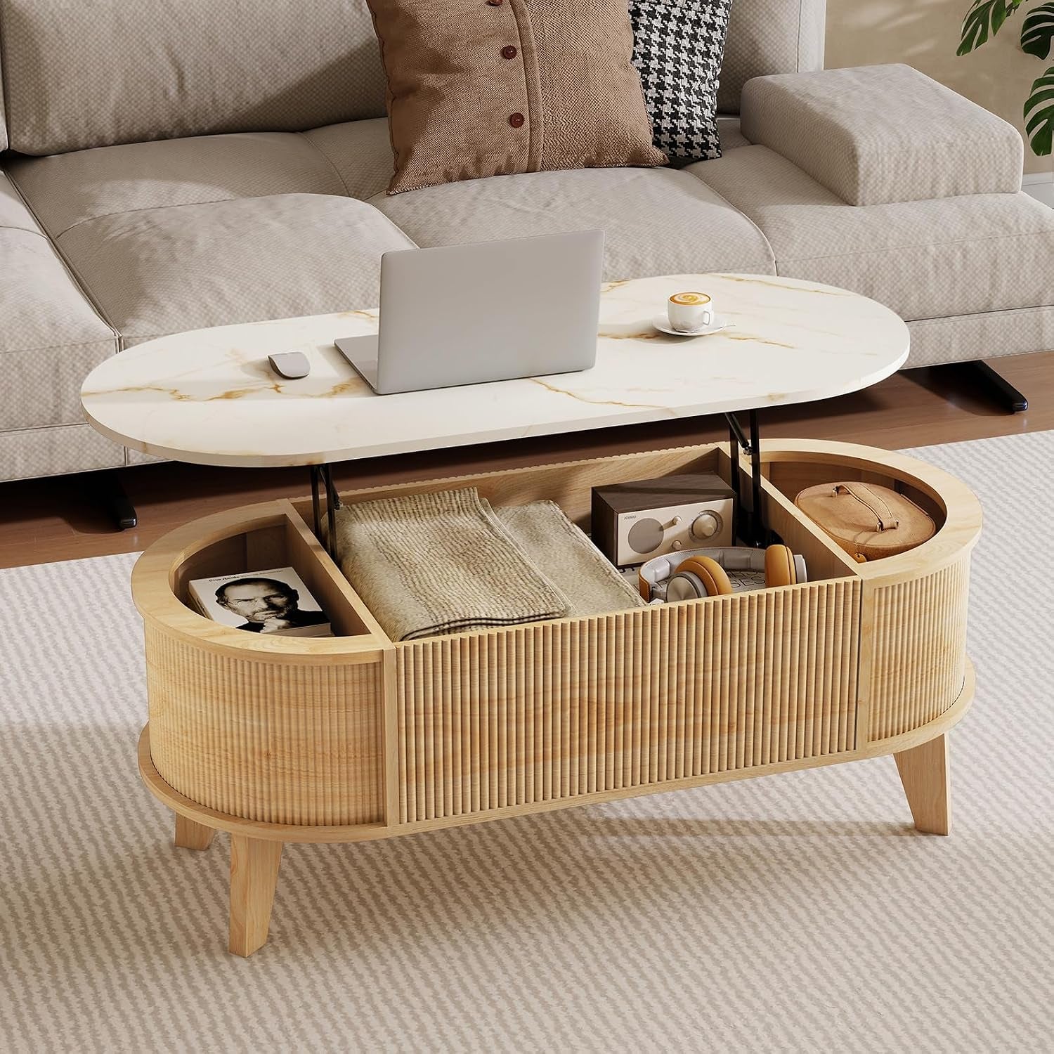Light wood oval lift-top table with white top raised, showing interior compartments and folded throw