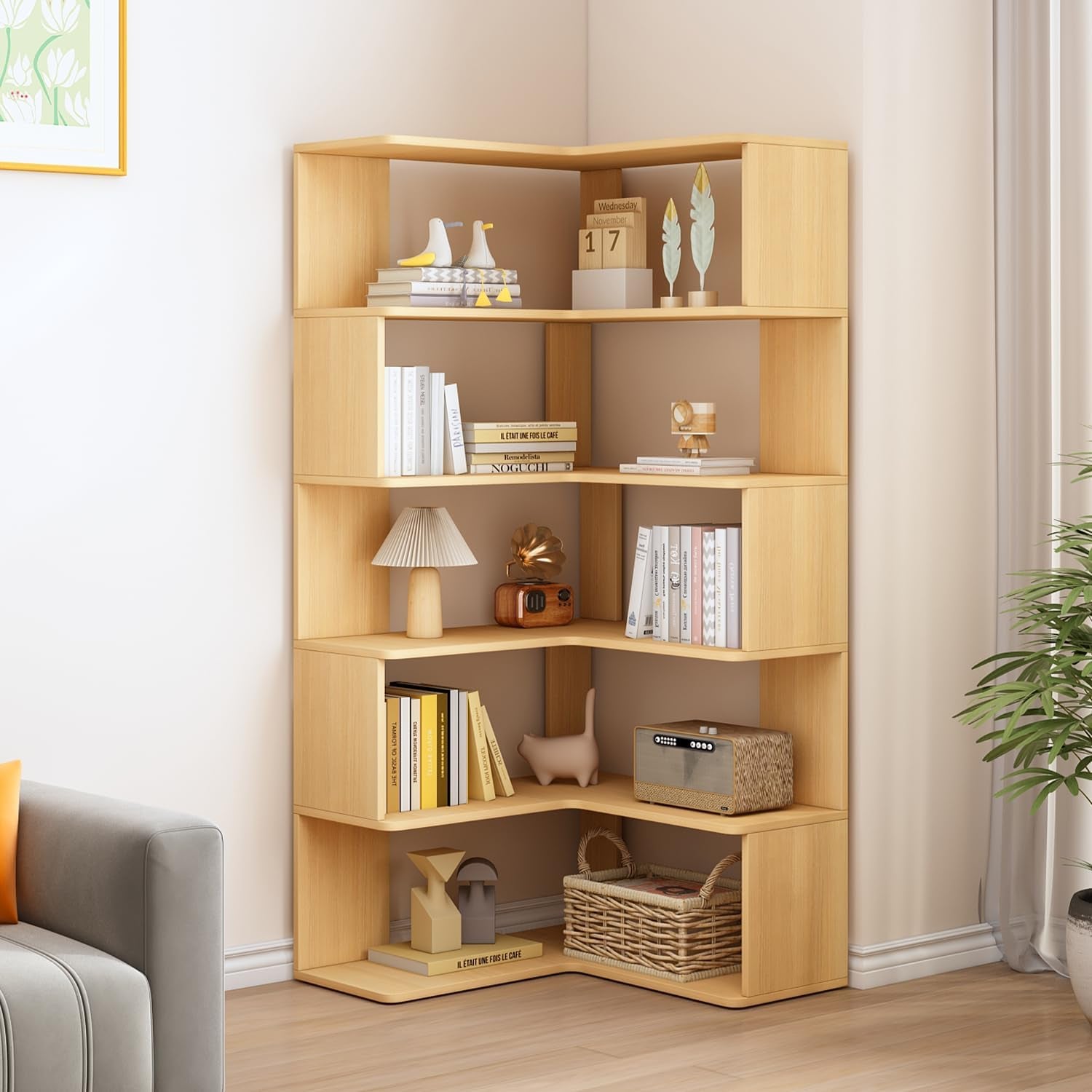 Corner bookshelf with six open L-shaped shelves holding books, decor, a lamp and a woven basket.