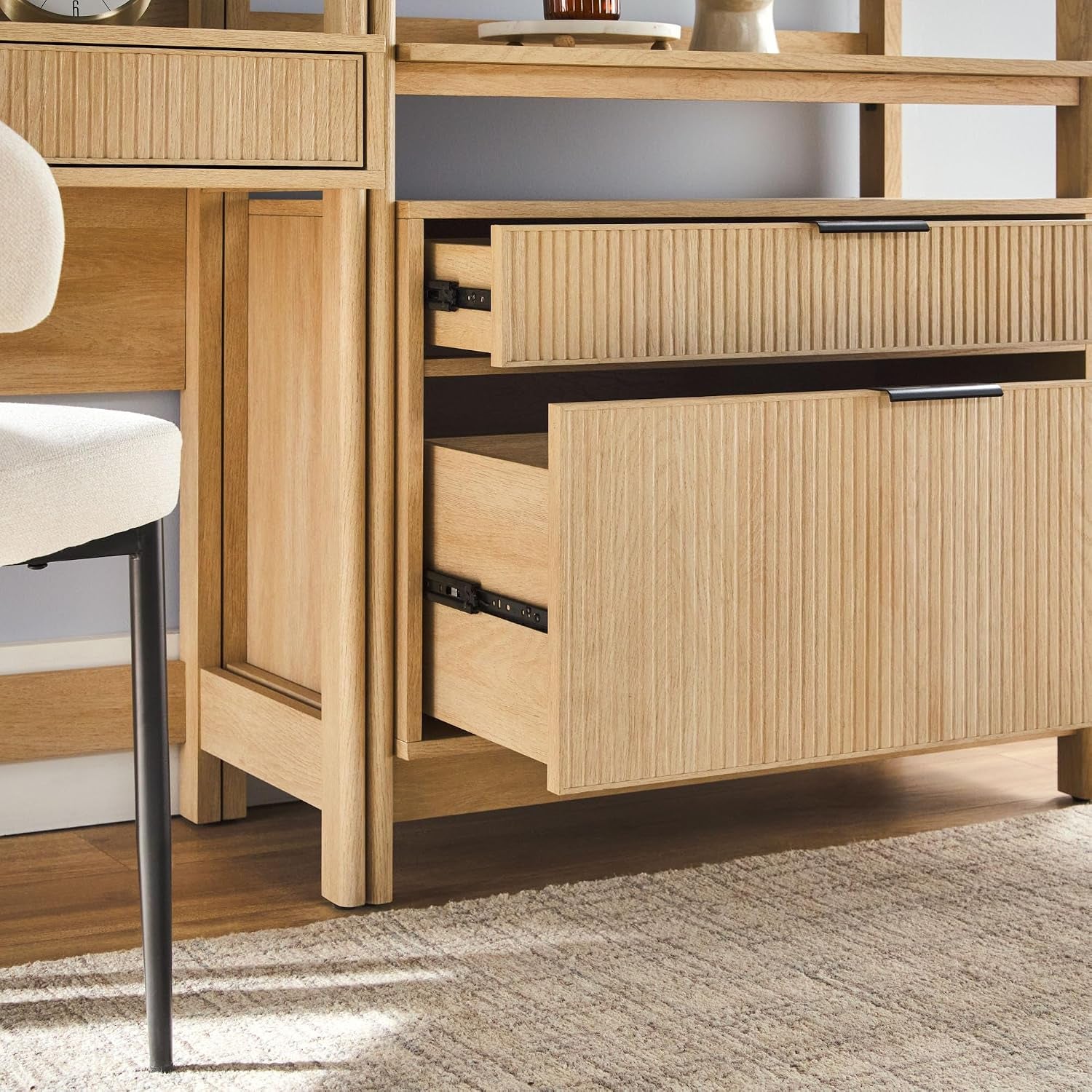 Detail close-up of an open drawer and lower cabinet showing interior storage and metal drawer slides in the two-piece set.