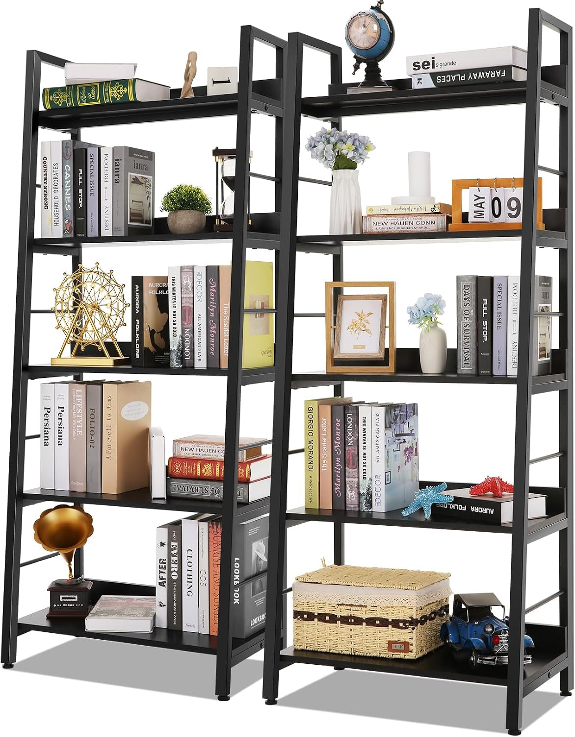 Front studio shot of two matching ladder bookcases filled with framed photos, small plants, a woven basket and toy car.