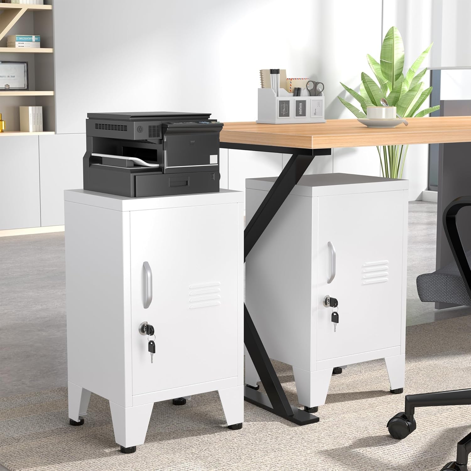 Office scene with two white steel lockers under a desk, one supporting a printer and the other beside an office chair.