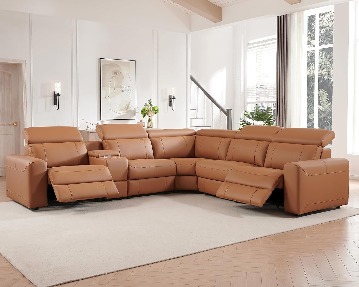 Warm tan leather reclining sectional with center console and two extended footrests in staged room