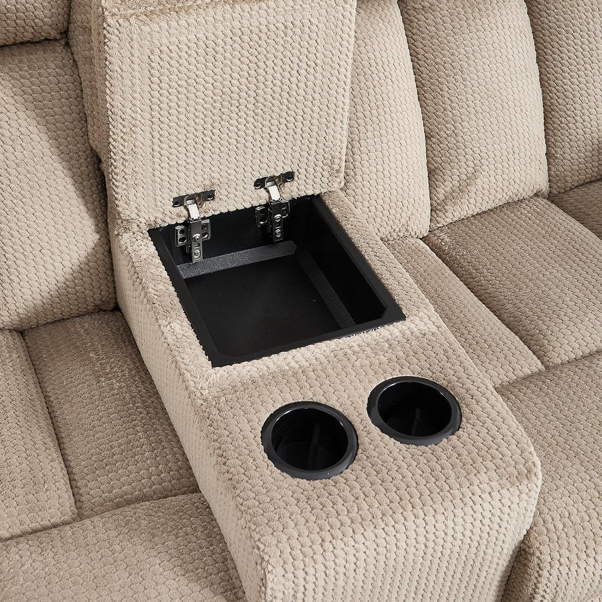 Light brown fabric center console close-up showing an open storage compartment and two cup holders