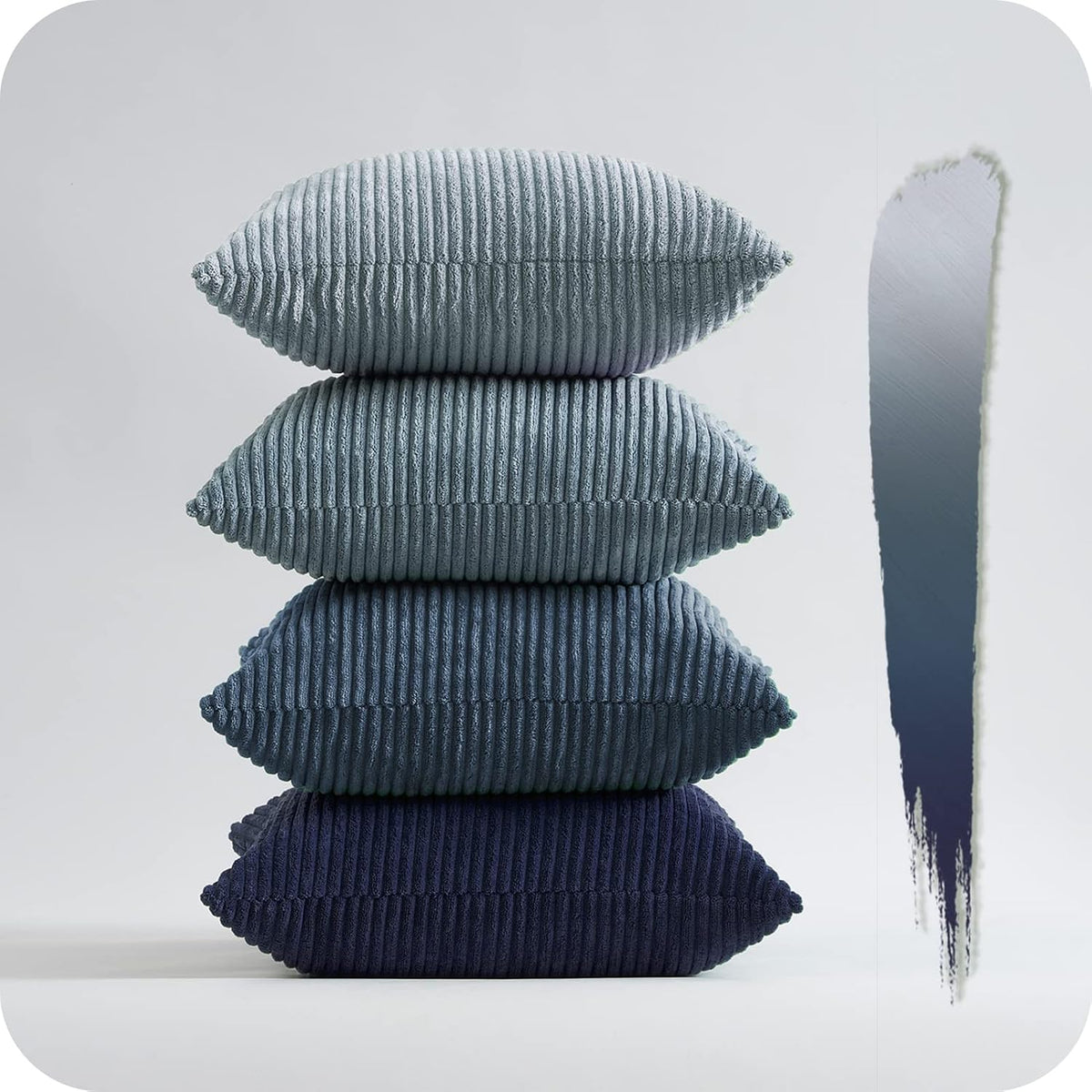 Tower of four ribbed corduroy pillows in blue-to-navy gradient beside a paint swatch