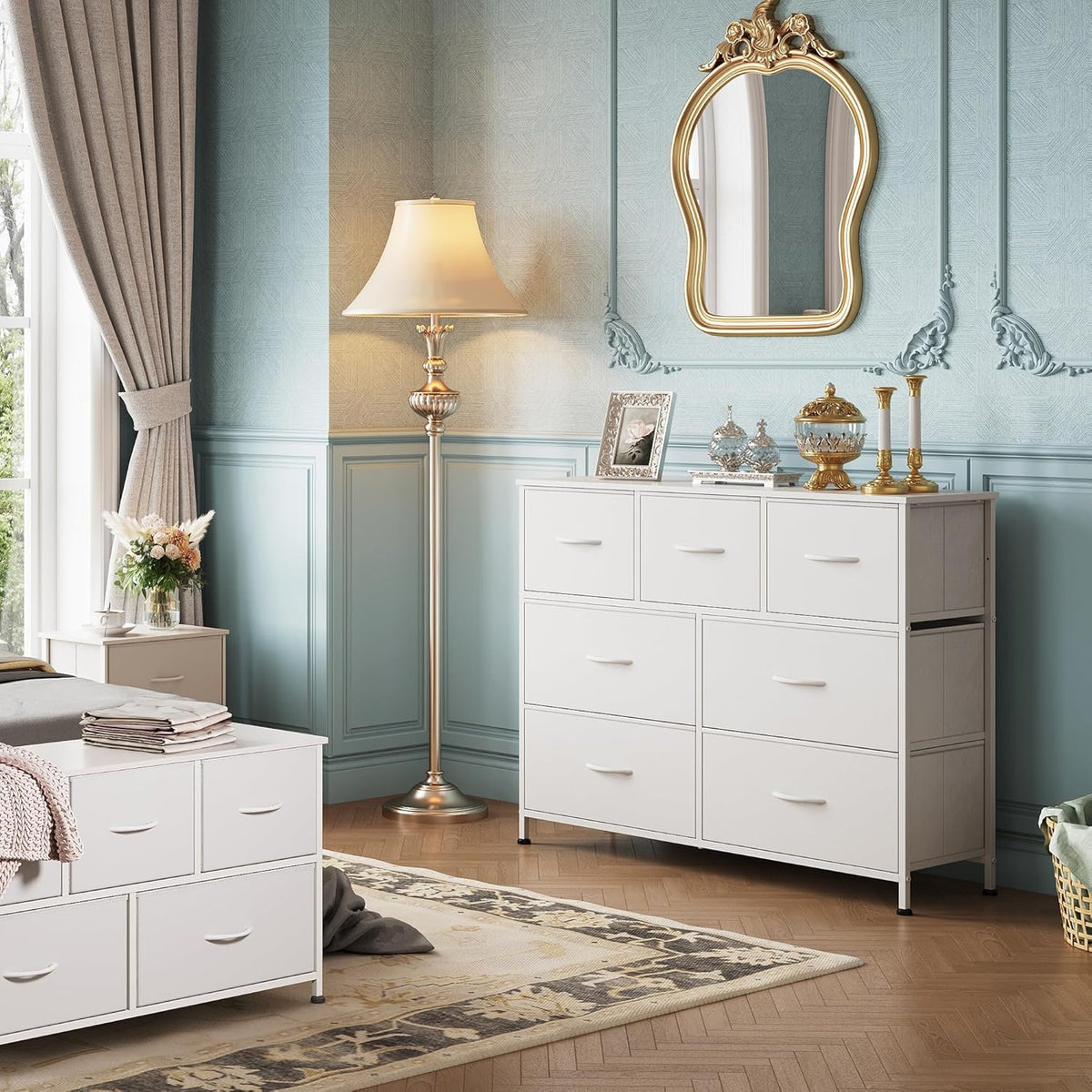 White dresser in a bedroom setting beside a matching low cabinet