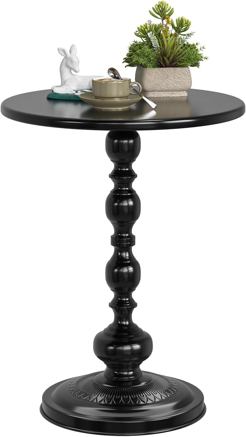 Black round metal side table close-up showing turned pedestal and decorative round base