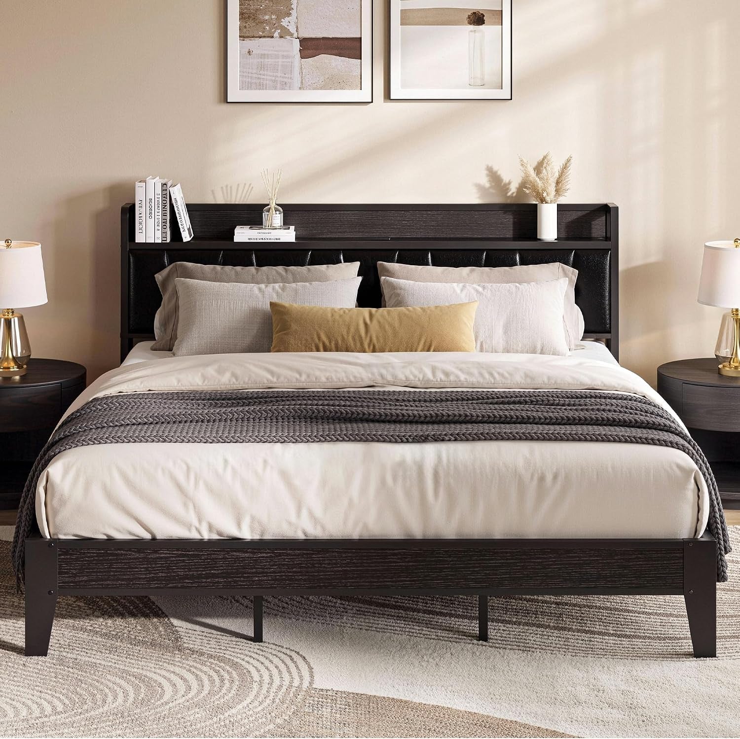 Neutral bedroom with dark wood-tone bed frame, black padded headboard, light bedding and round bedside tables.