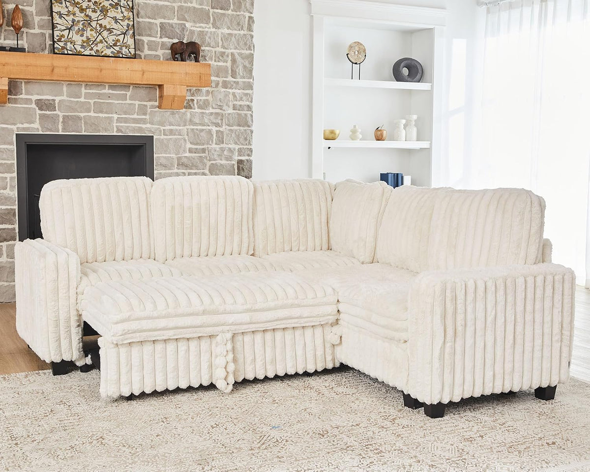 Three-quarter view of a cream corduroy modular sectional beside a stone fireplace in a bright living room.