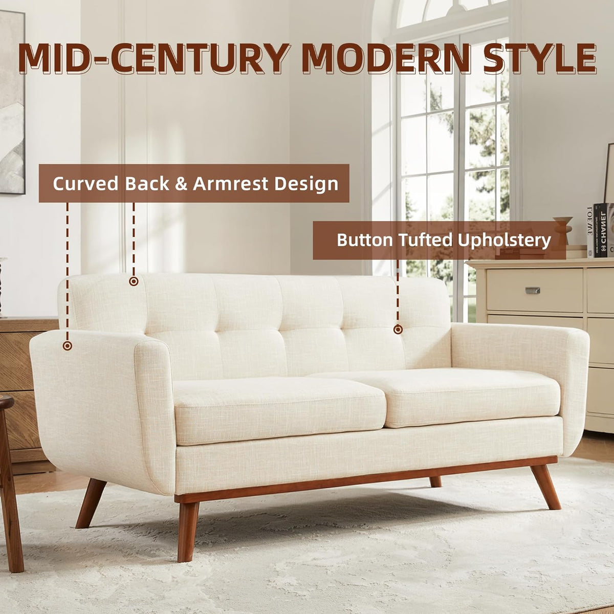 Beige mid-century loveseat staged in a bright living room with tufted back and angled wooden legs.