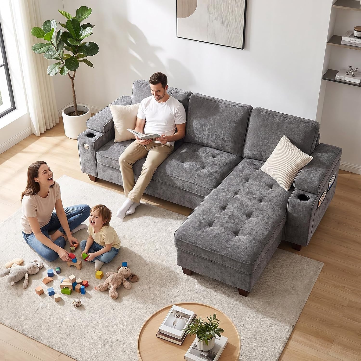 Overhead view of a gray sectional with chaise while a family plays on the rug beside it.