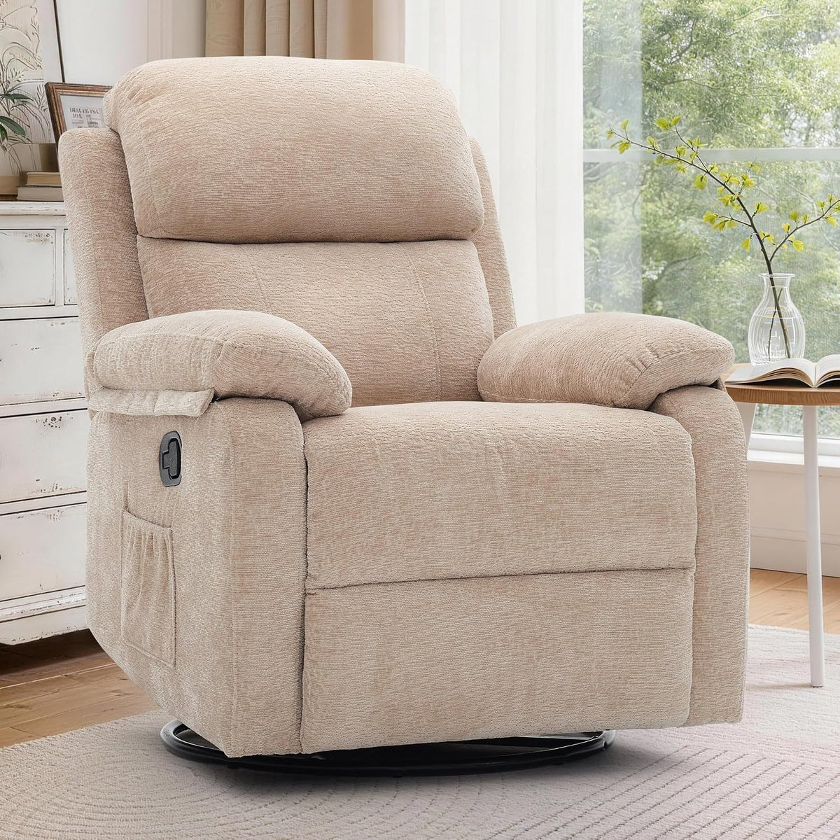 Beige upholstered swivel recliner displayed in a bright room with a small round table and window behind