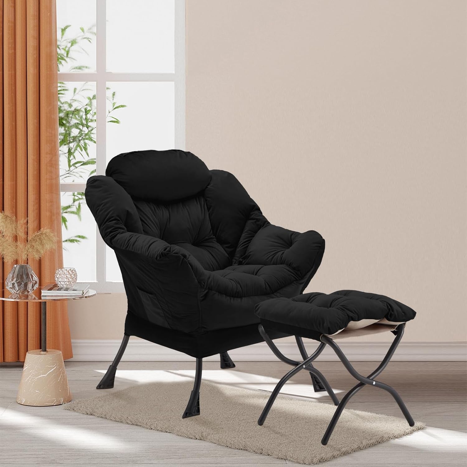 Black velvet lazy chair and ottoman staged in a living room setting on a rug near a window