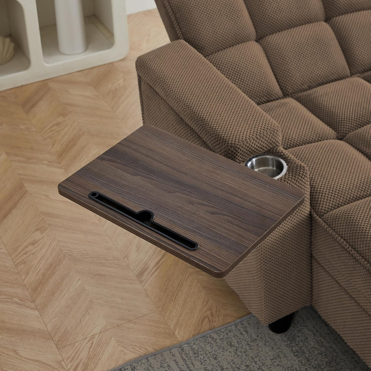 Wood-grain swivel tray extended over armrest showing rectangular phone slot and rounded cup holder next to it.