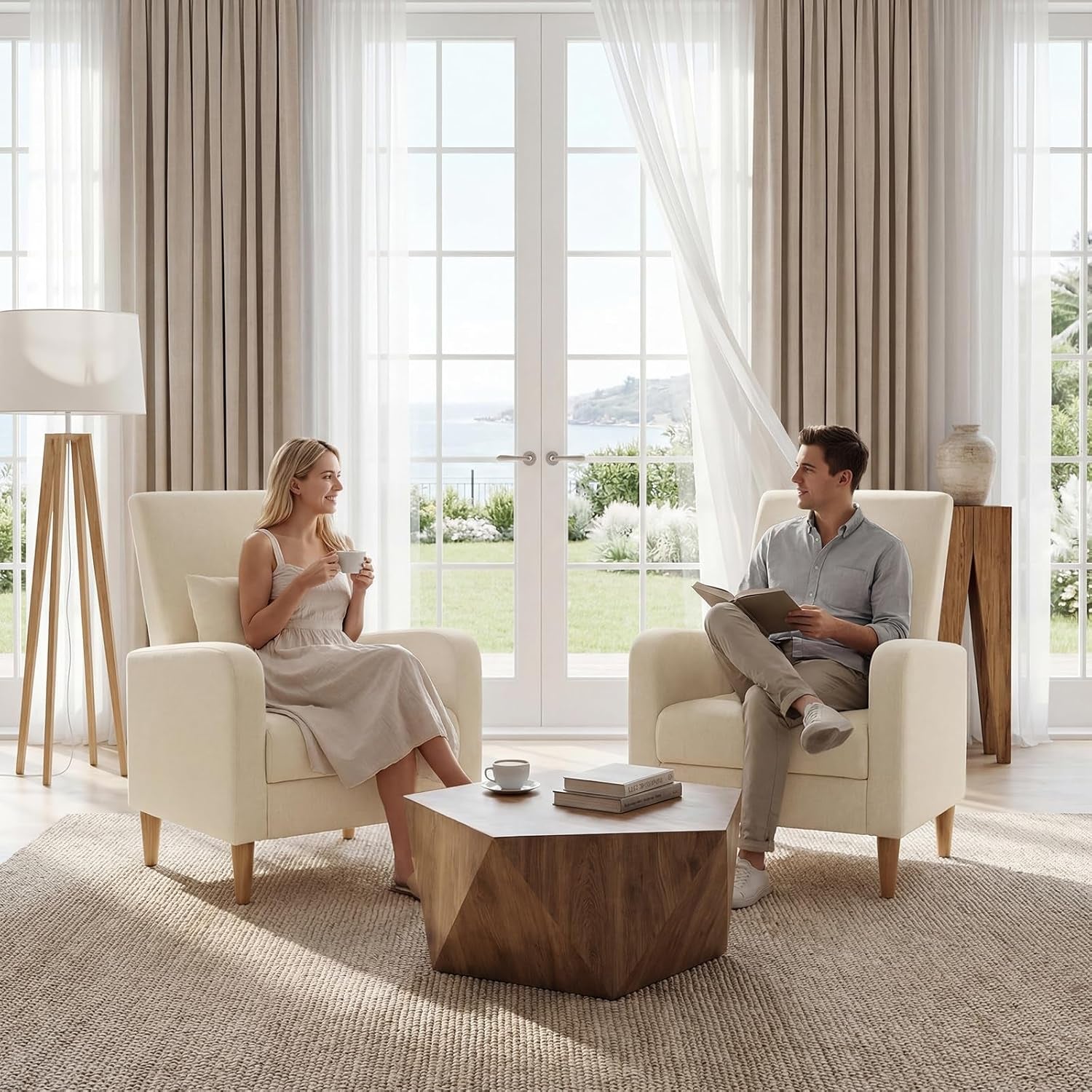 Two beige upholstered armchairs with wood legs in a sunlit living room, people seated, wooden coffee table and French doors