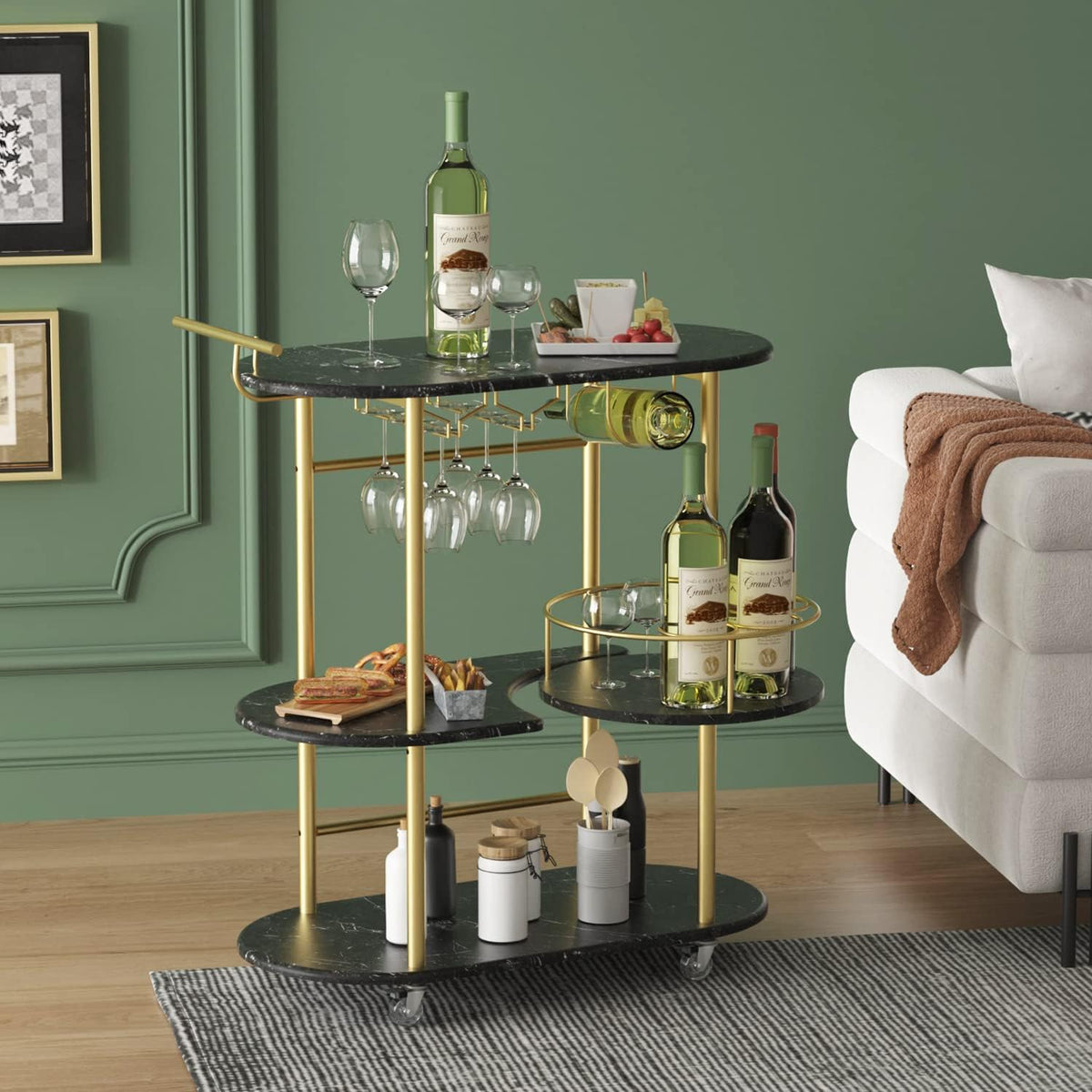 Black marble-topped bar cart with gold supports and glass holders next to a white couch