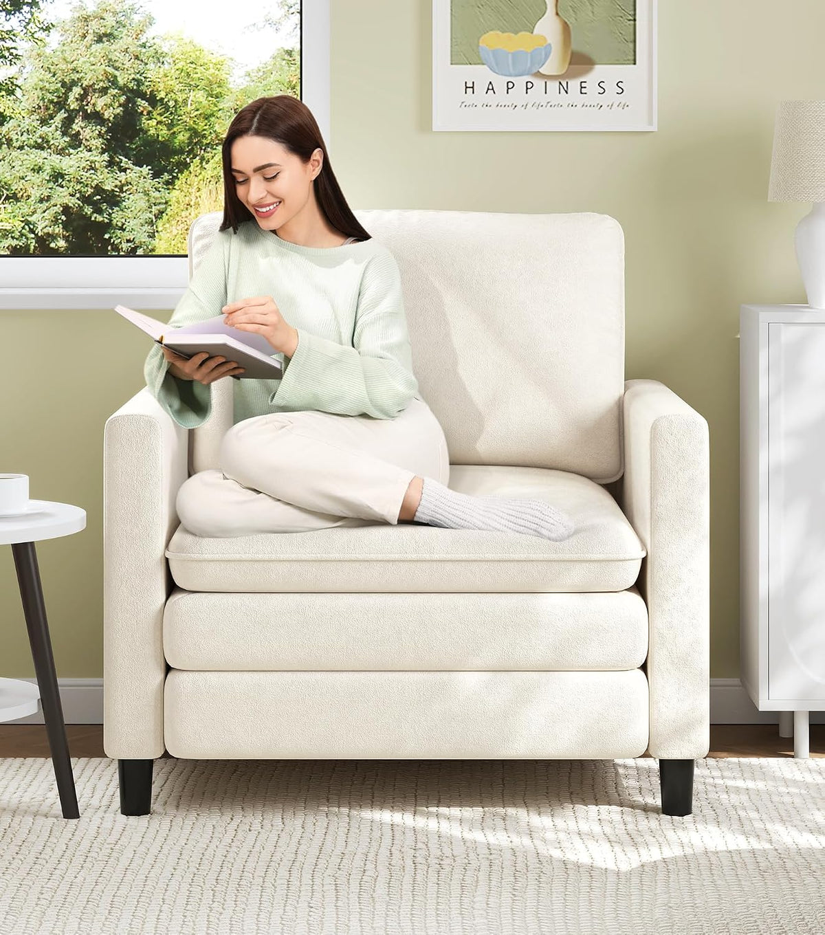 Off-white single-seat loveseat shown front-on with woman reading a book while seated cross-legged.