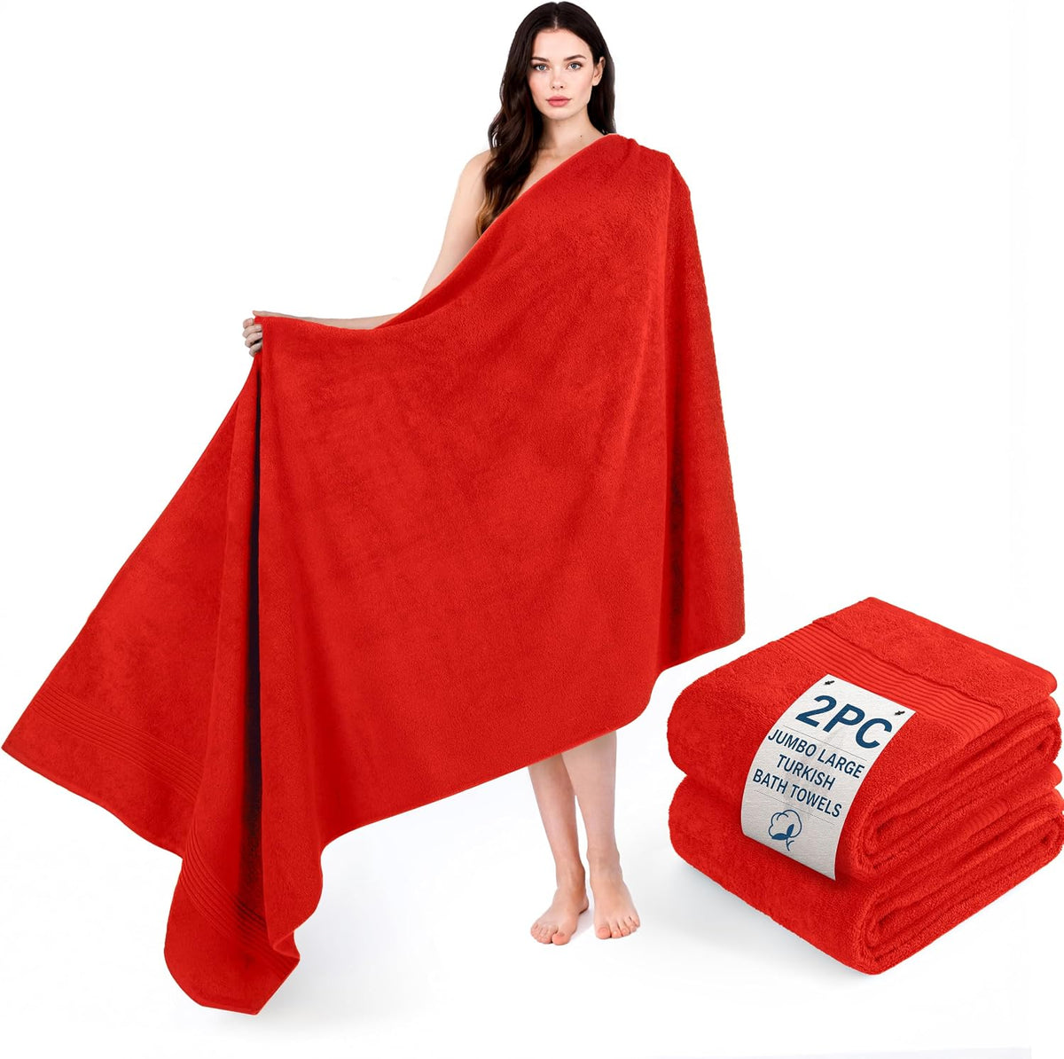 Woman wrapped in a large red towel with a matching folded red towel set displayed at her feet.