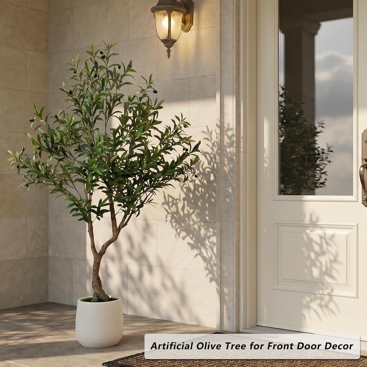 Artificial olive tree staged beside a front door in a porch setting showing scale and shadow