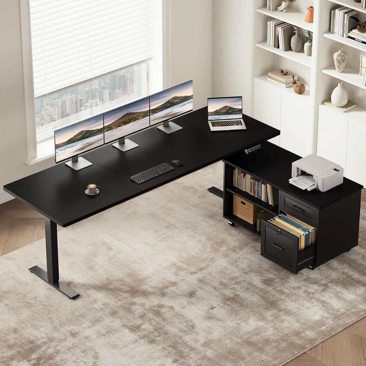 Black L-shaped standing desk with black cabinet, three monitors and printer on the return surface.