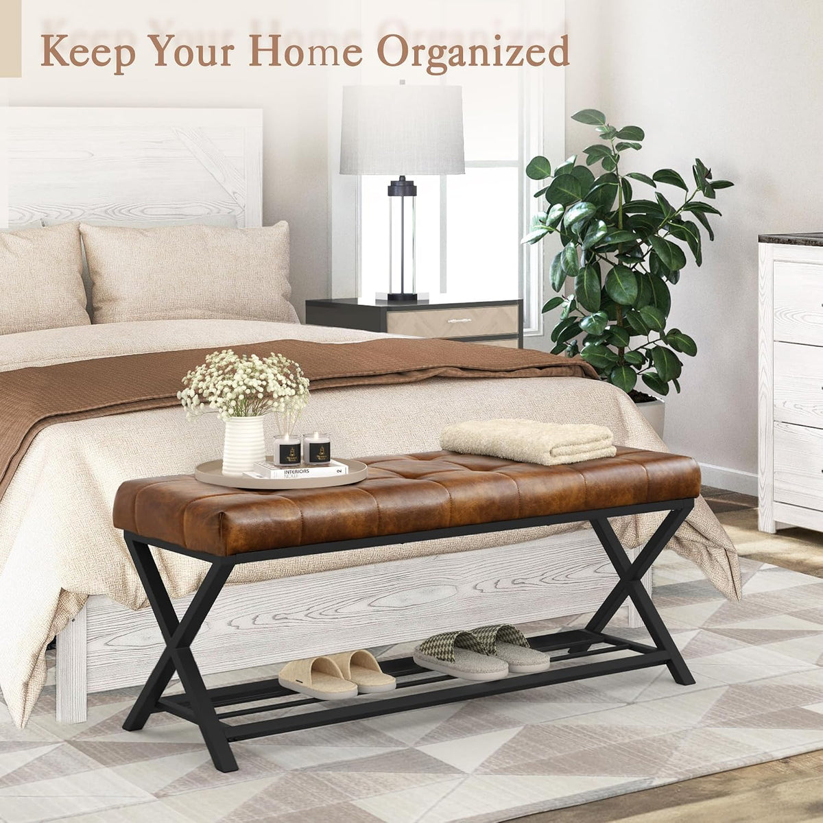 Tufted bench at the end of a bed in a neutral bedroom setting, front view