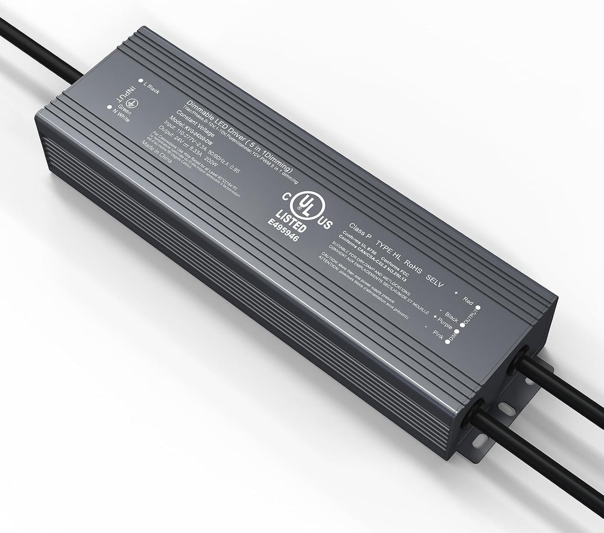 Close-up of a dark gray ribbed rectangular LED driver with three black cables protruding on a white surface.