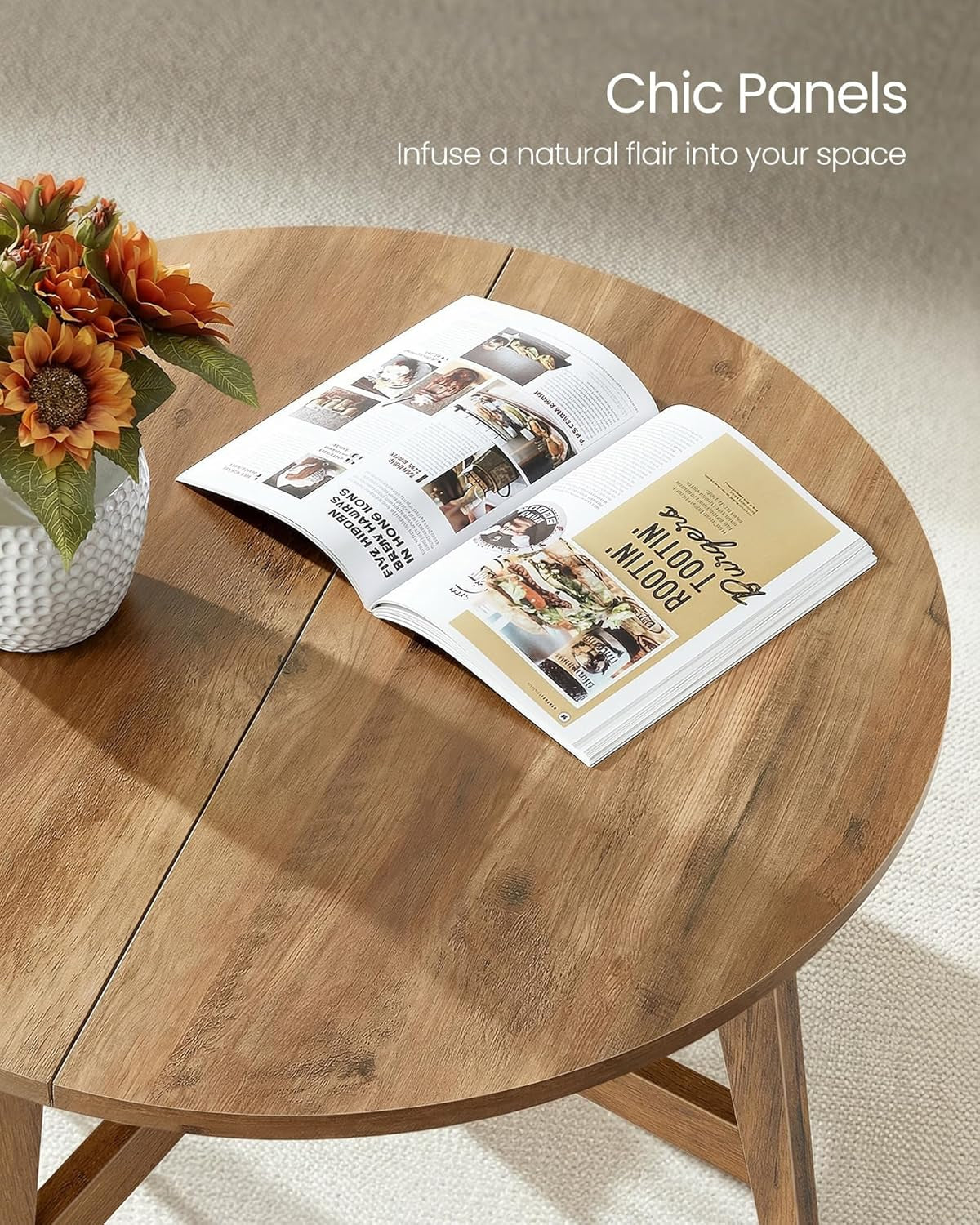 Close-up of brown round coffee table top with an open magazine and vase