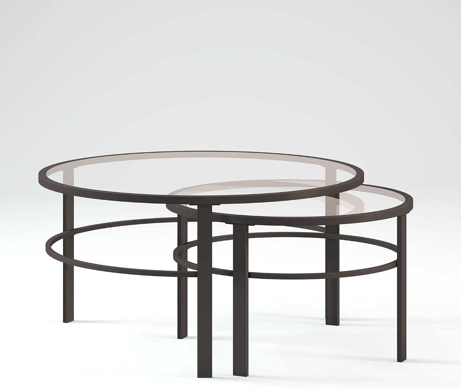 Low-angle close-up of two nested round tables showing overlapping circular support rings and glass tops.