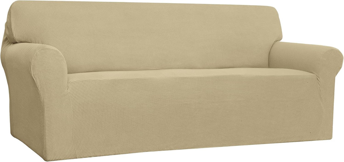 Three-quarter view of a two-seat sofa with a light beige textured slipcover
