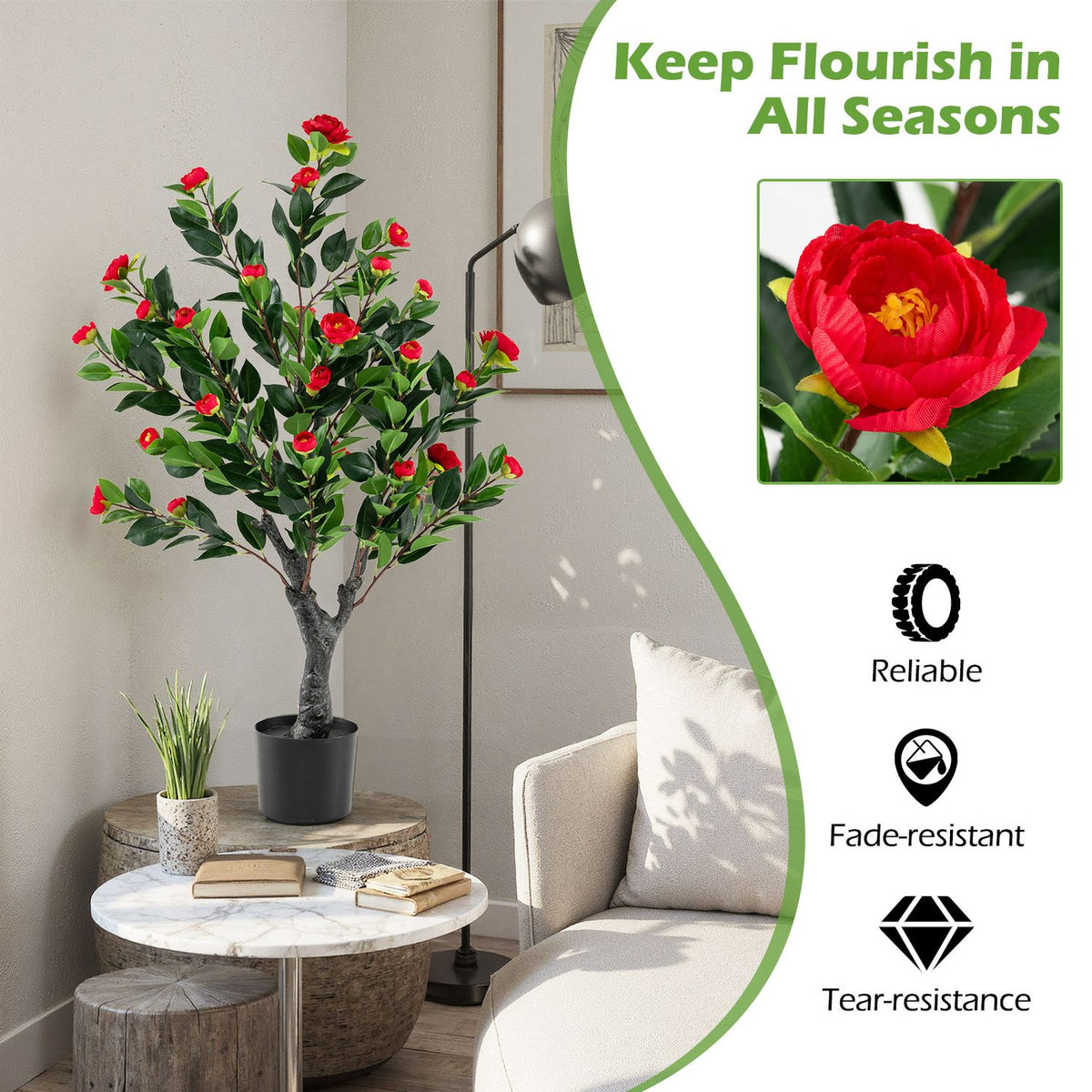 Red-blossomed camellia tree beside a living-room table with flower detail panel