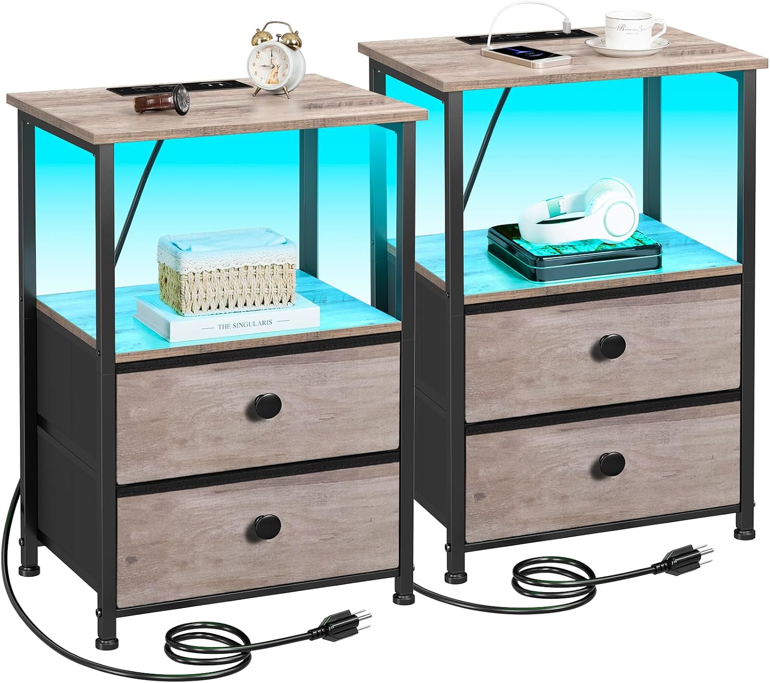 Two light weathered-gray nightstands staged with small decor on shelves and charging cable coiled at base