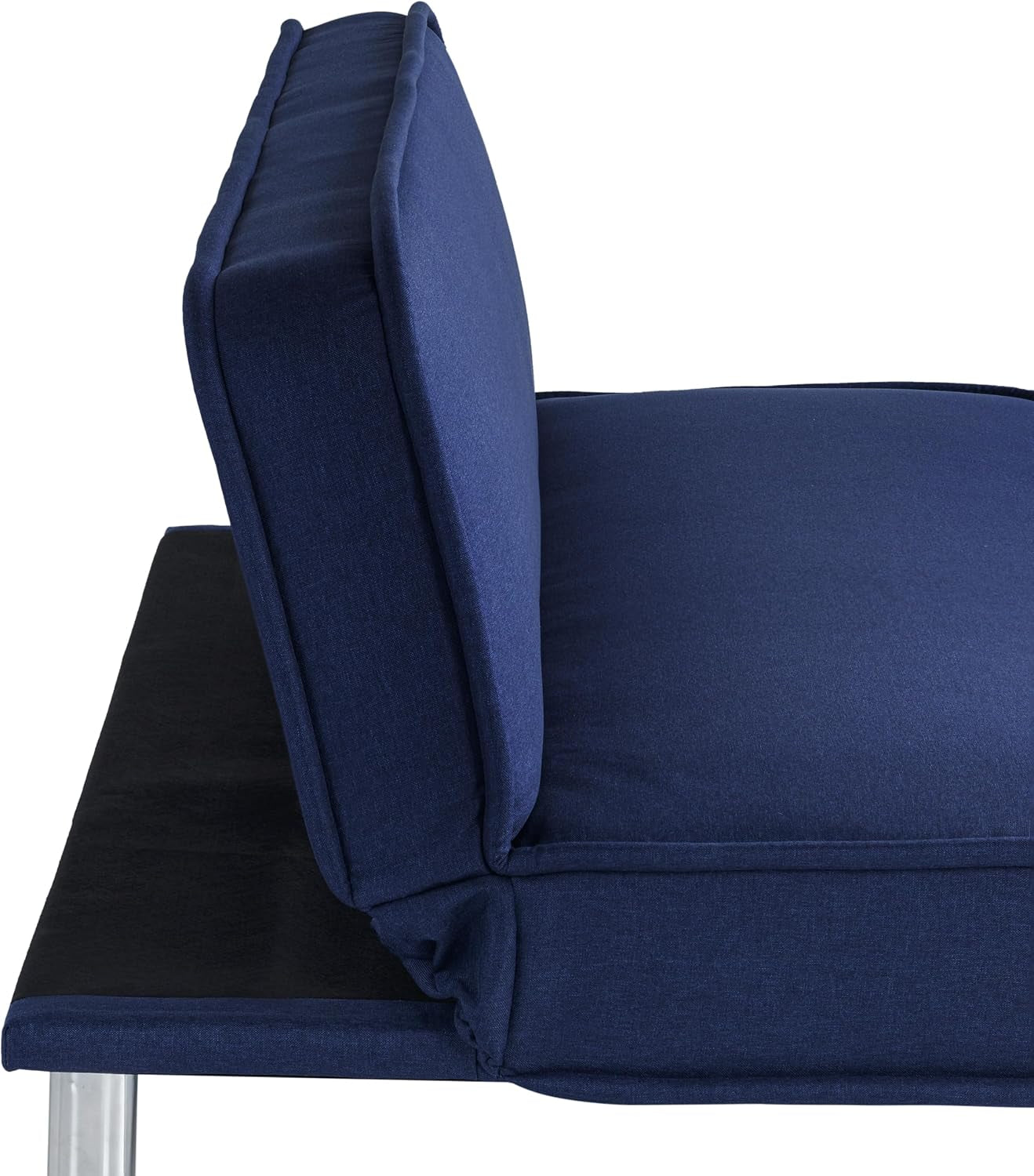 Close-up side view of navy futon back and seat cushion junction with chrome leg visible.